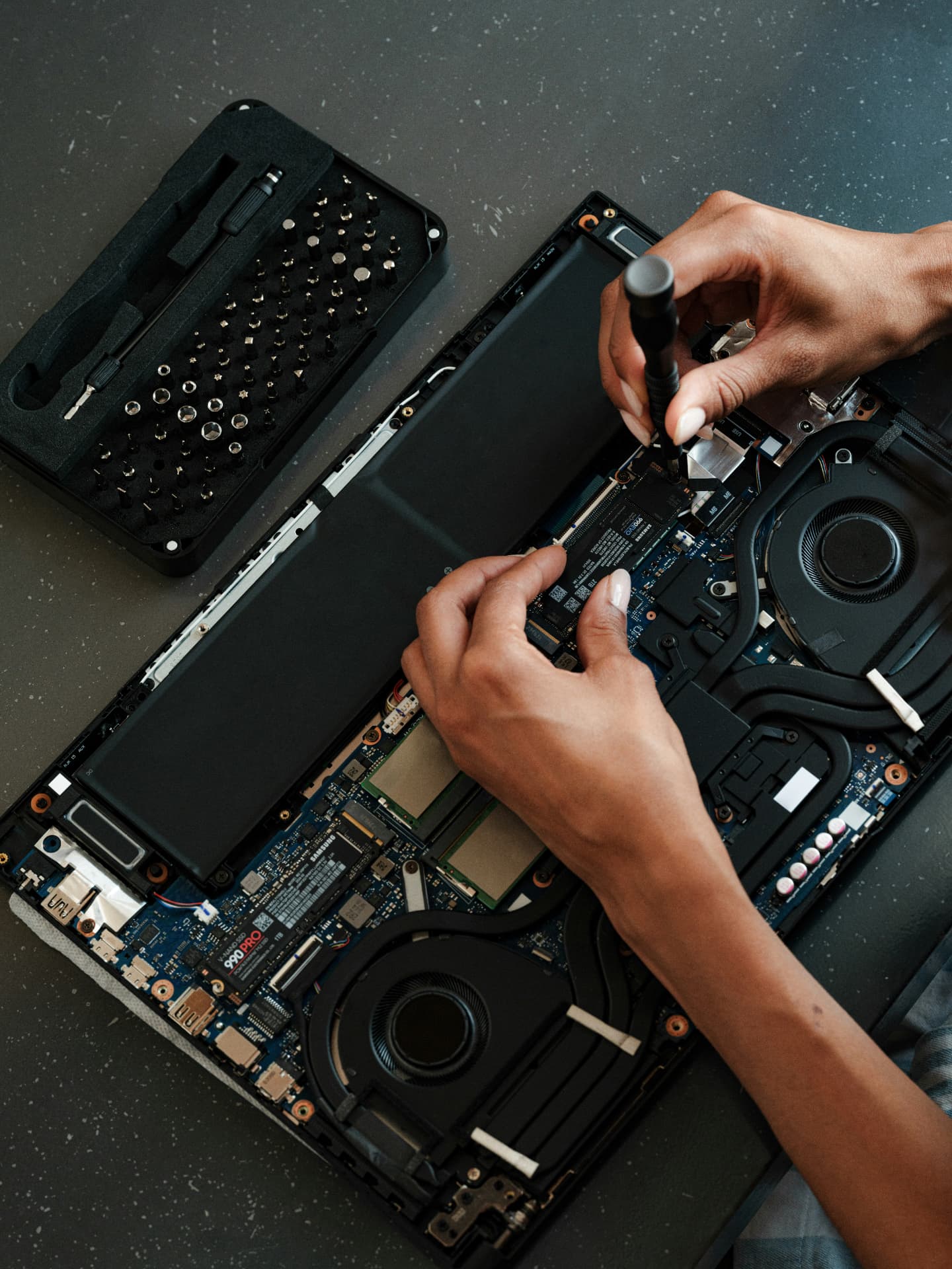 Snappy Techs technician servicing the internal components of an open laptop