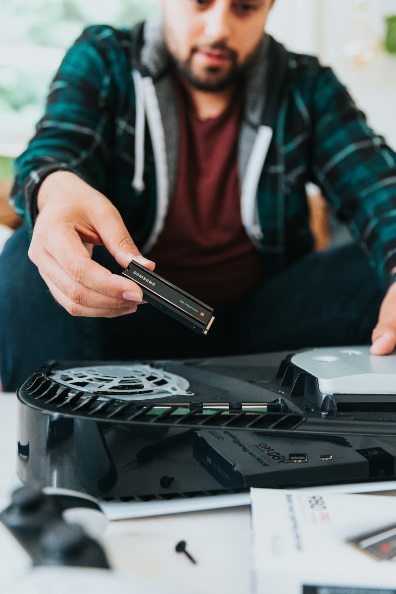 Solid-state drive being installed during a gaming console upgrade