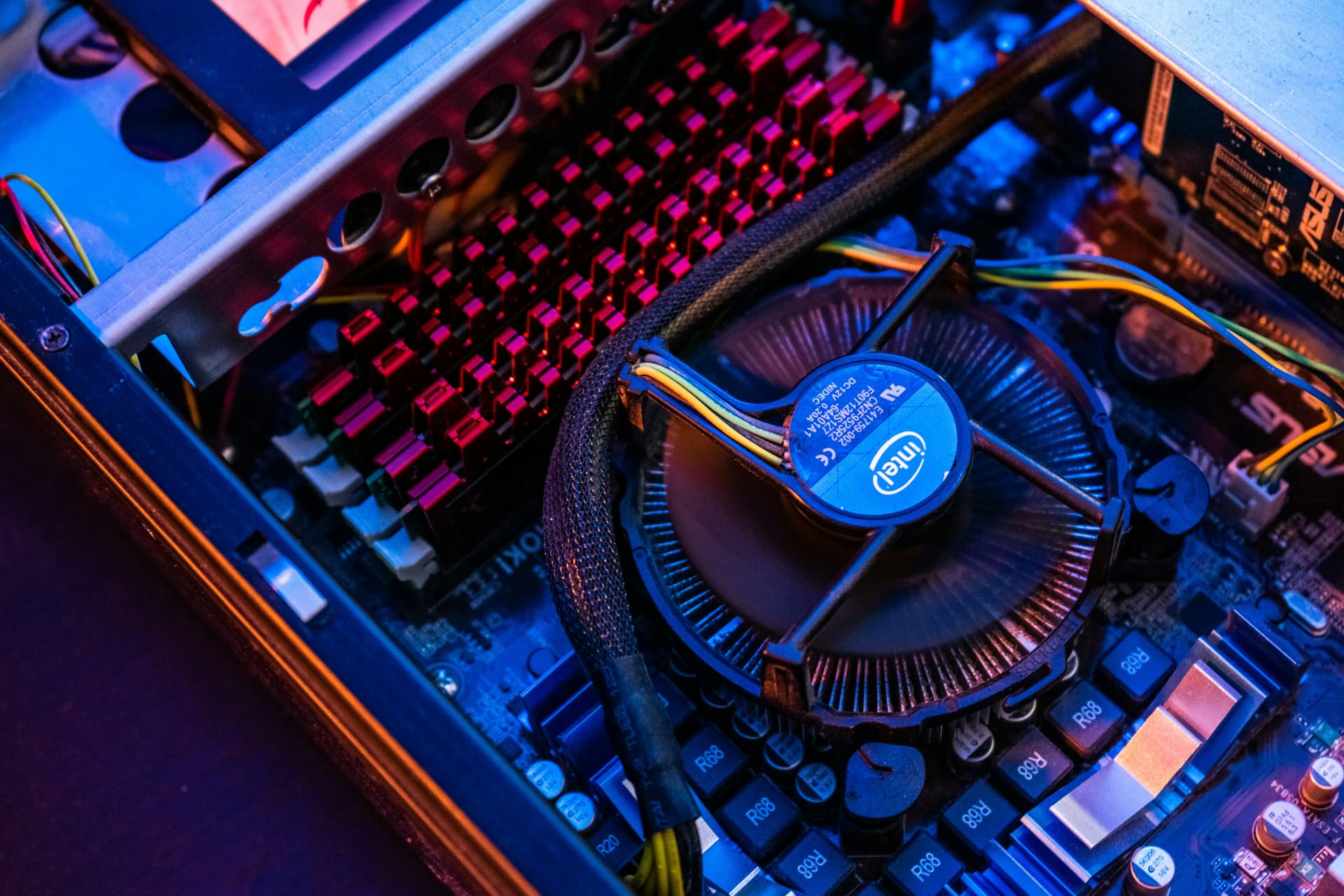 Desktop computer cooling fan and motherboard under diagnostic lighting