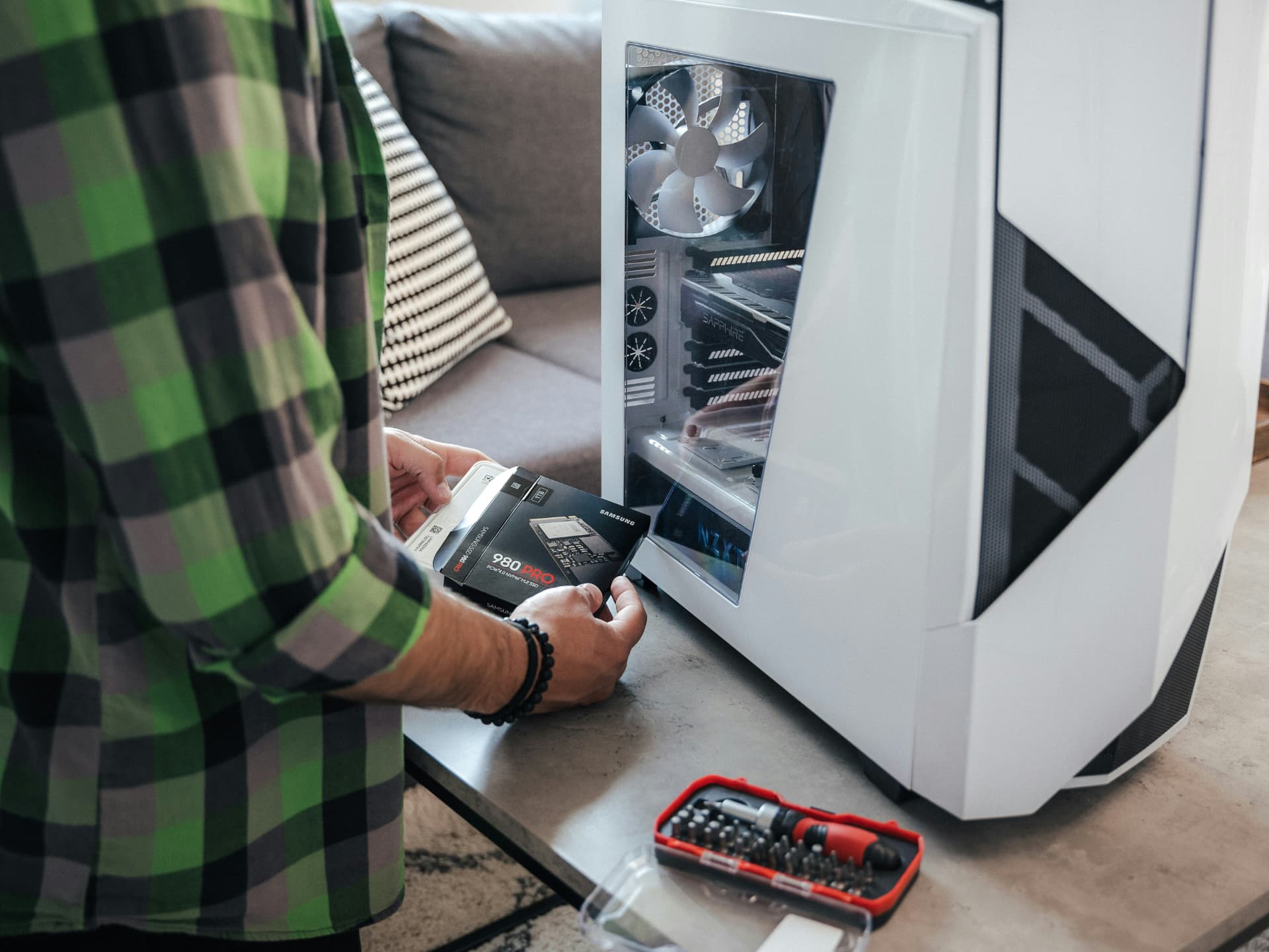Technician preparing a solid-state drive upgrade for a desktop computer