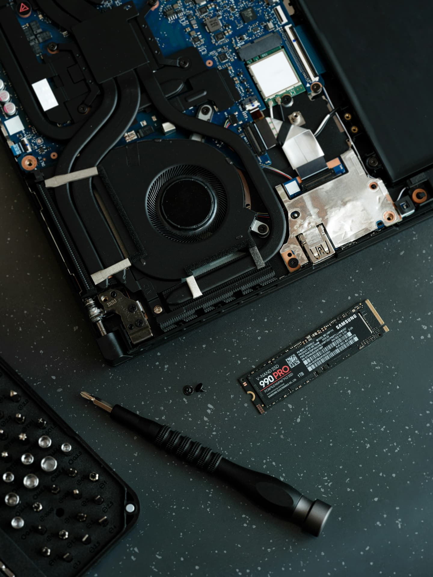 Laptop cooling fan, logic board and solid-state drive during diagnosis