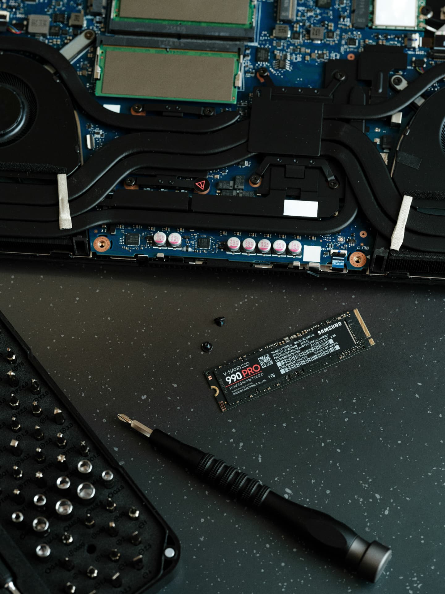 Close view of a laptop logic board, cooling system and solid-state drive